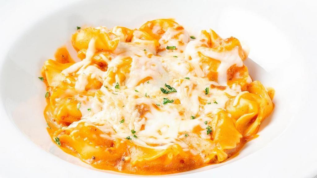 Baked Cheese Tortelloni · Cheese stuffed tortelloni with a creamy meat sauce. Baked with Mozzarella and Parmesan.