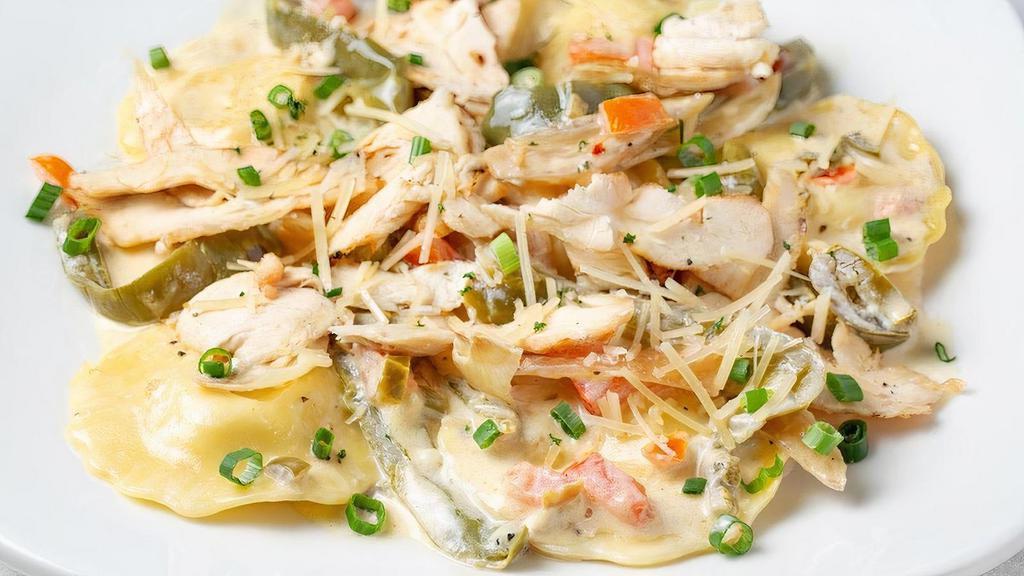 Grilled Chicken Jalapeño Ravioli · Italian cheese-filled ravioli cooked in a green chile jalapeño Alfredo sauce with onions and peppers. Topped with grilled chicken, tomatoes, green onions and Parmesan cheese.