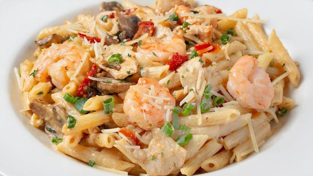 Spicy Shrimp & Chicken · Penne sautéed with shrimp, sliced chicken, cayenne pepper, Romano cream sauce, mushrooms,. sun-dried tomatoes and green onions.
