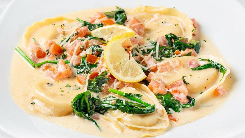Lobster Ravioli · Served with spinach, Roma tomatoes, Asiago and lemon basil cream sauce.