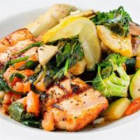 Lemon Pepper Salmon* · Marinated in Italian herbs, topped with sautéed artichoke hearts, Roma tomatoes, spinach and...