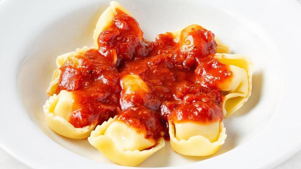 Cheese Tortelloni · Cheese-stuffed pasta with tomato sauce.