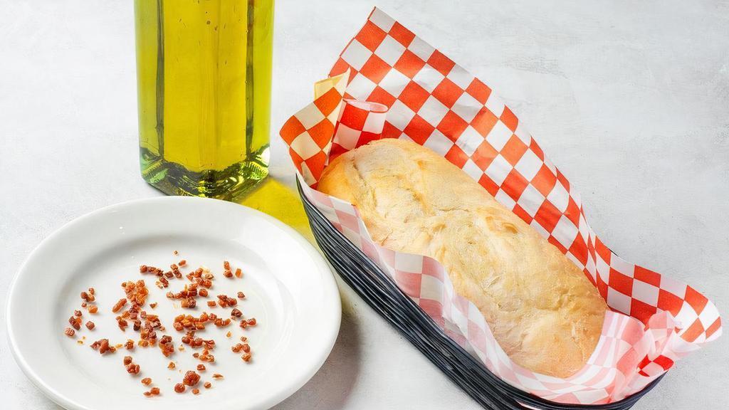 Add An Additional Loaf Of Bread · Fresh-baked loaf of Tuscan bread. Served with a side of olive oil and garlic.