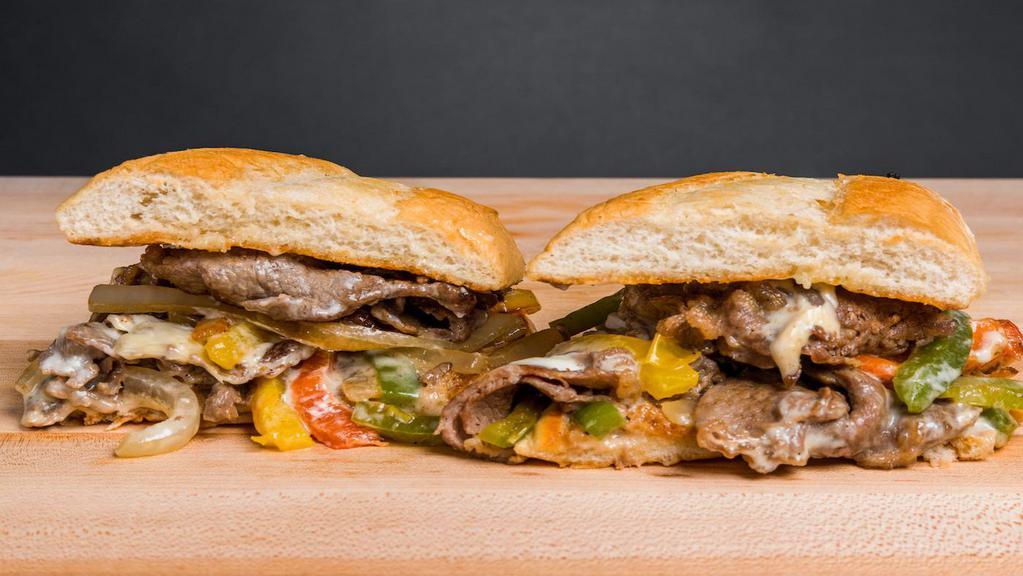 Philly Cheesesteak · Freshly baked french roll with thinly sliced ribeye, bell peppers, onions, swiss cheese, and mayonnaise.