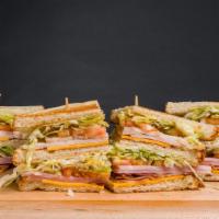 Club Sandwich · Toasted white bread with bacon, ham, cheese, turkey, lettuce, tomato, and mayonnaise.  Serve...