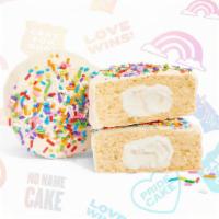 Pride Cake - Limited Edition · A vanilla cake filled with creamy frosting, covered in a candy coating and topped rainbow sp...