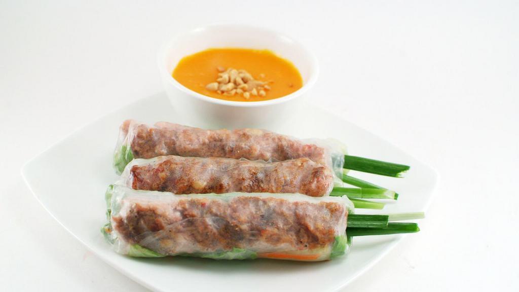 Nem Nướng Cuốn - Seasoned Pork Patty Spring Rolls · Contains gluten. 3 - seasoned pork patty wrapped in rice pepper with cucumber, lettuce, carrot, daikon & mint served with roasted garlic dipping sauce.