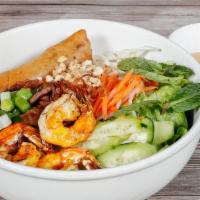 Bùn Đặc Biệt · Contains gluten. Grilled pork egg rolls, pork patty, shrimp with rice noodles on a bed of le...