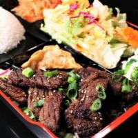 Sesame Beef Box · Diamond cut beef with a sesame garlic marinade, served with rice, salad, jabchae, and a pots...