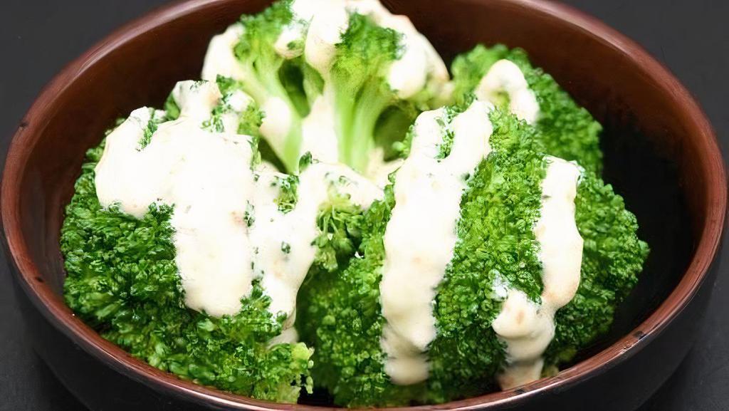 Broccoli · Steamed broccoli topped with house made white sauce.