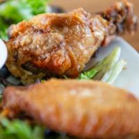 Chicken Wings · Six pieces. Marinated in our famous garlic mojo, served with our homemade cilantro cream dip.