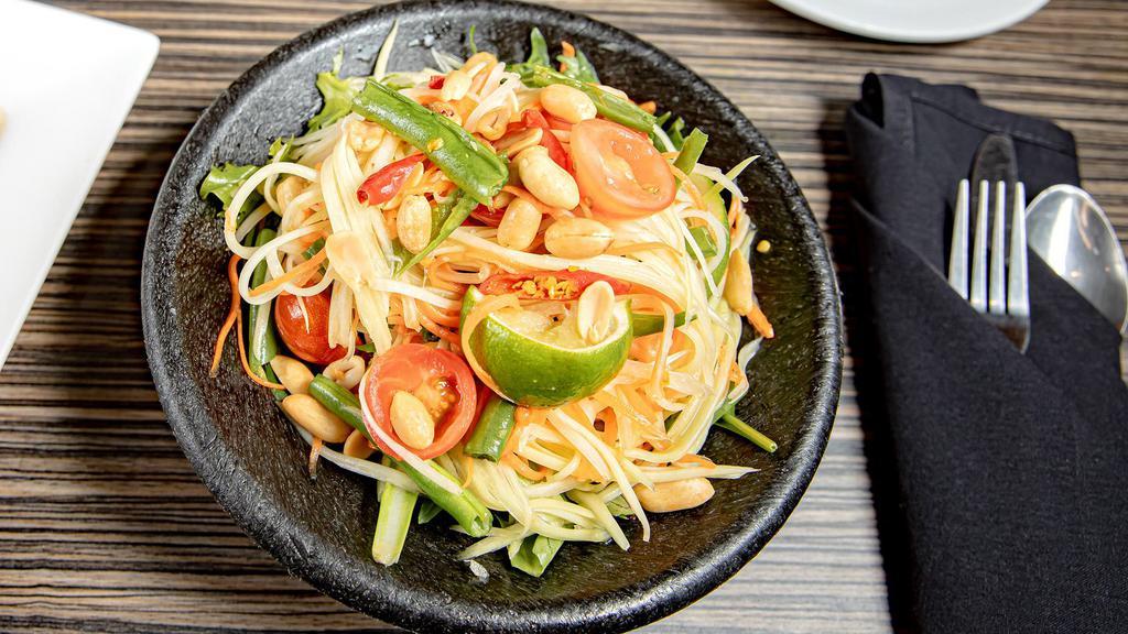 Som Tum · Gluten free. Green papaya with cherry tomatoes and green beans, topped with peanuts.