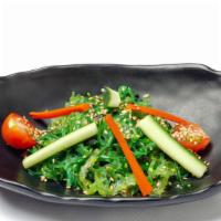 Seaweed Salad · Seasoned seaweed salad topped with carrot zuke, tomato, cucumber, sesame seeds