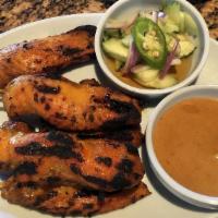 Satay (6 Pieces) · Marinated chicken or beef on a skewer, grilled to perfection served with peanut sauce and cu...