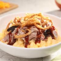 Slow Smoked Pulled Pork · Slow-smoked pulled pork served over mac-n-cheese and topped with crispy onions.