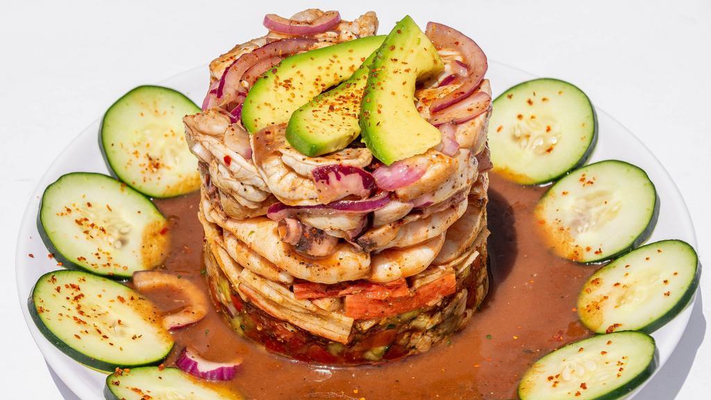 The Tower · Crab meat, cooked shrimp, octopus, shrimp cooked in lime juice, scallops served on ceviche with our delicious salsa negra.