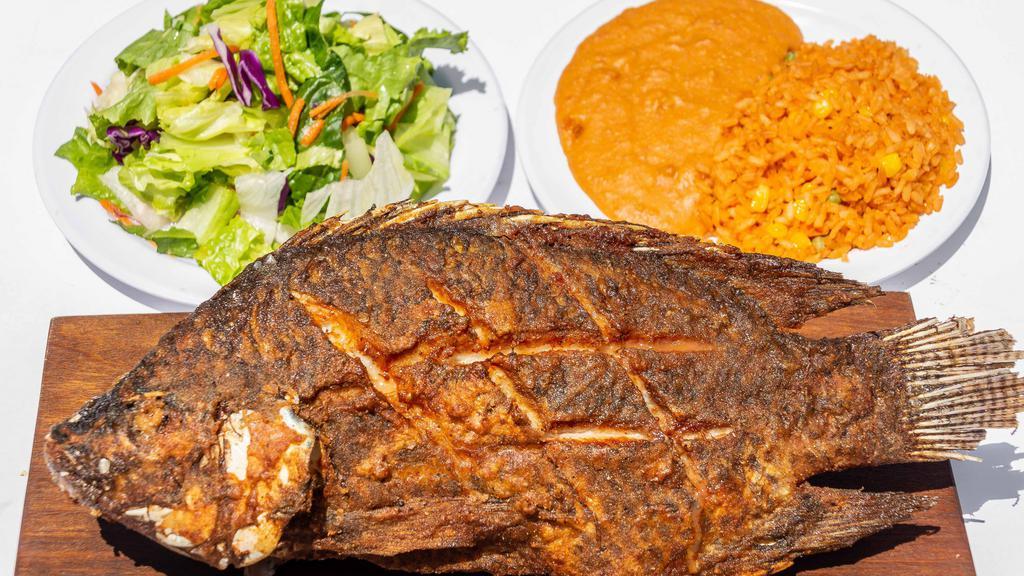 Fried Fish · Deep fried fish served with beans, rice and salad.