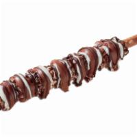 M&M Pretzel Rod · Pretzel rod rolled in caramel and m&m's  drizzled with milk chocolate.