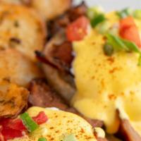 Eggs Benedict · Two poached eggs on a toasted English muffin, hollandaise sauce, and choice of one of the fo...