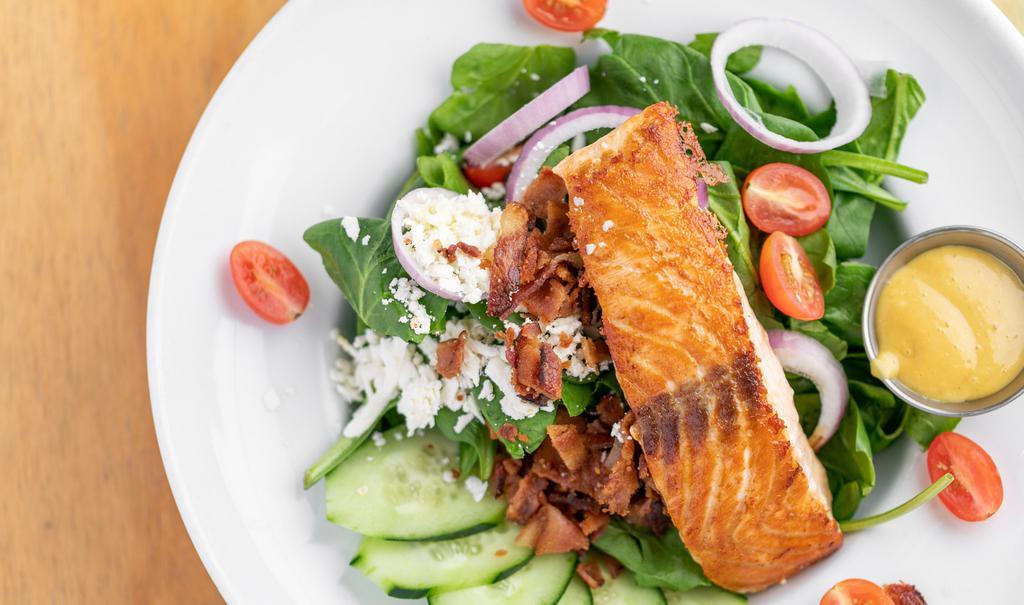 Spinach Salmon Salad · Grilled salmon, diced bacon, red onions, spinach, tomatoes, feta cheese and honey mustard dressing.