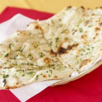 Garlic Naan · Leavened with flour bread baked in a clay oven with garlic.