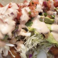 Baja Lover Burrito · Beer battered shrimp and fish, pico de gallo, cabbage, avocado, house sauce.