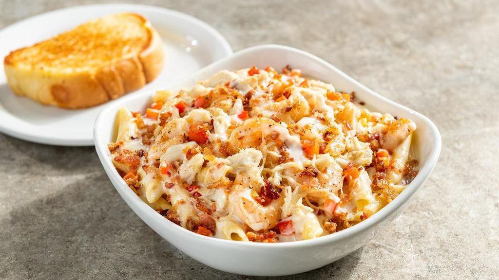 Baked Seafood Pasta · Fresh baked crab, garlic shrimp, diced red bell pepper, bacon over a bed of penne pasta with Alfredo sauce & shredded Parmesan.