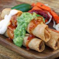 Three Taquitos Con Guacamole · Rolled taquitos with shredded chicken or beef.