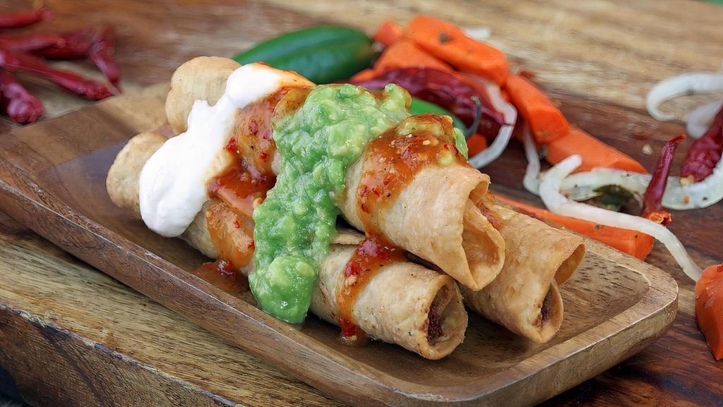 Three Taquitos Con Guacamole · Rolled taquitos with shredded chicken or beef.