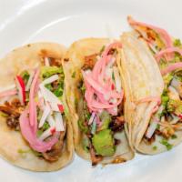 Street Taco Trio · Three soft tacos served on handmade corn tortillas with guacamole and a trio of mild, hot an...