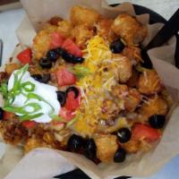Spudchos Porkytizers · This is our spin on nachos! Your choice of Fries, Tater Tots, or Chips, smothered with our c...