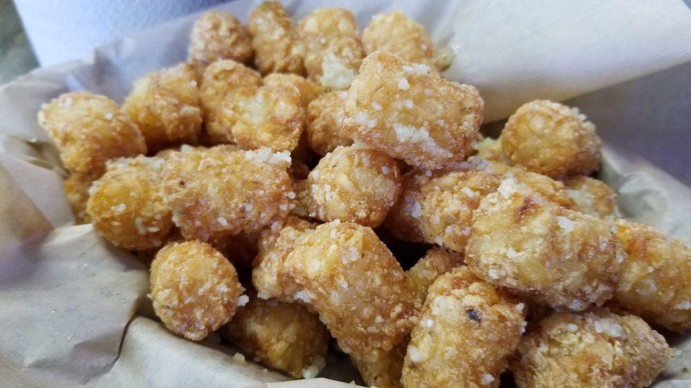 Garlic Spuds · Your choice of fries, tots, or chips, tossed with our secret garlic Parmesan mix.