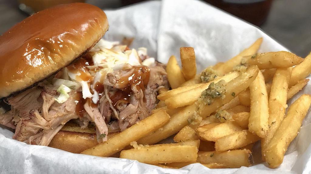 Pulled Pork Sammich · Our Championship winning Pulled Pork on a butter toasted brioche bun, topped with our homemade slaw and a drizzle of bbq sauce, served with one side.