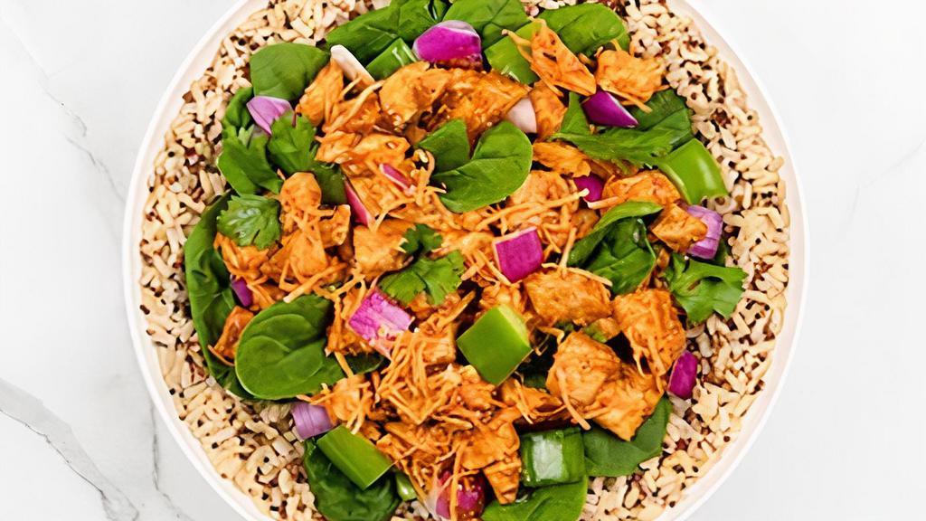 Thai Buddha · Quinoa and Brown Rice topped with chicken, onions and bell peppers grilled in Thai and Schug sauce and; carrots, cilantro and spinach.