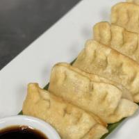 Pot Stickers · Chicken and vegetable filled pot stickers served with house ginger soy dipping sauce.
