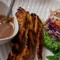 Chicken Satay · Grilled skewered strips of chicken breast marinated in coconut milk seasoned sauce.