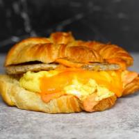 Croissant Sausage, Egg And Cheddar Sandwich · 2 fresh cracked cage-free scrambled eggs, melted Cheddar cheese, breakfast sausage, and Srir...