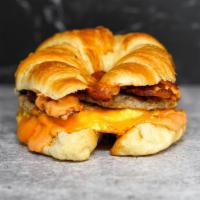 Croissant Big Breakfast Sammy · 2 scrambled eggs, melted Cheddar cheese, bacon, breakfast sausage, and Sriracha aioli on a w...