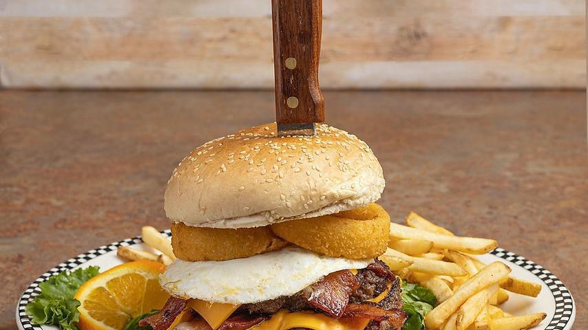 The Big Daddy Burger · Our biggest burger ever!. Two 10 oz burger patties served on a sesame bun with onion rings, a fried egg, bacon, cheese, lettuce, tomatoes, pickles, mayo and Thousand Island dressing.  . Served with golden French fries..
