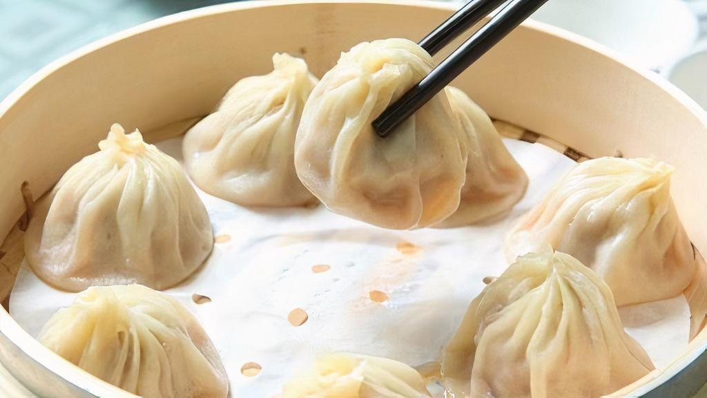Steamed Pork Dumplings (8Pc) · Steamed pork dumplings with dipping sauce.