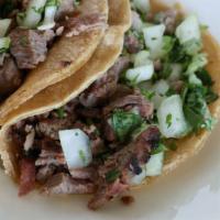 Street Tacos · Beef, chicken or carnitas served open-faced on two corn tortillas. Topped with cilantro, dic...