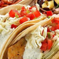Grilled Fish Tacos · Two corn tortillas with grilled tilapia, tomatillo mayonnaise, shredded cabbage, pico de gal...
