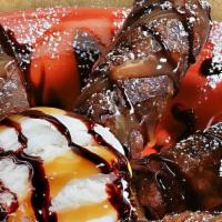Chocolate Mini Chimis · Chocolate tortillas filled with sweet cream cheese and chocolate lightly fried and topped wi...