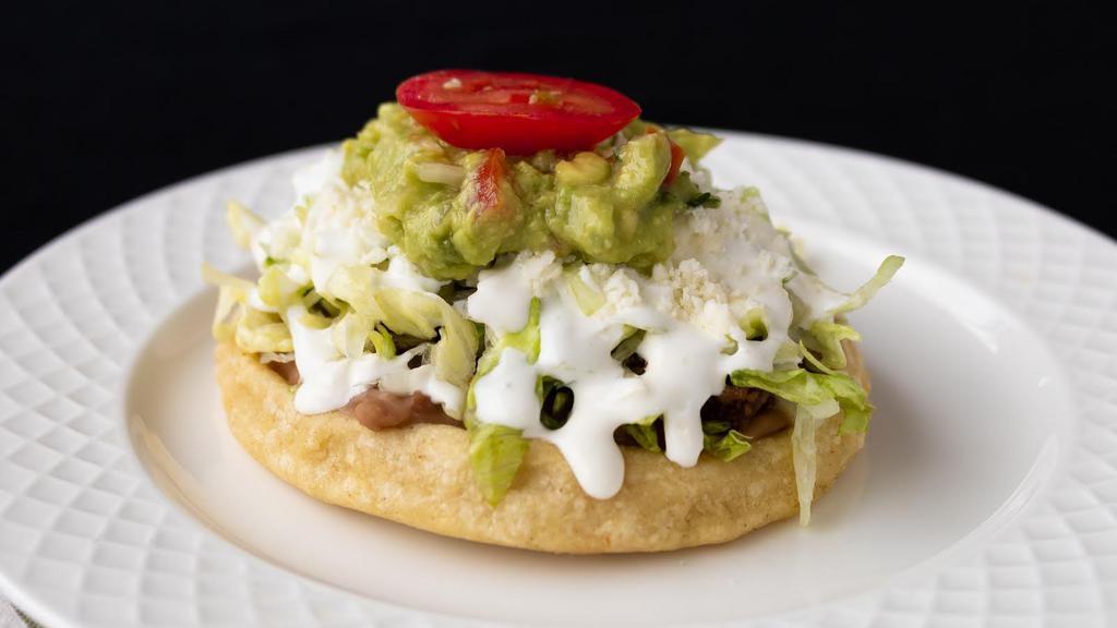 Sope · Fresh Homemade Corn Tortilla | Beans | Lettuce | Tomato | Mexican Cheese | Mexican Cream | Guacamole | Choice of Meat