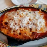Lasagna Bolognese · Housemade lasagna with beef ragu, mozzarella cheese, bechamel, and tomato sauce.