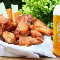 Baked Chicken Wings · Basket of wings served with one ranch dressing and carrot & celery sticks.