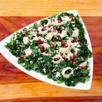 Kale Salad · Kale marinated in champagne vinaigrette, hearts of palm, pomegranate seeds, Feta and sunflow...