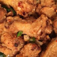 Salted Pepper Chicken Wings · Cooked wing of a chicken coated in sauce or seasoning. hot and spicy.