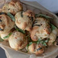 Garlic Knots · House-made dough, tied up, dipped in garlicky goodness and oven-baked. Served with flippin' ...