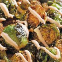 Honey Sriracha Brussels Sprouts · Savory, lightly fried brussels sprouts, perfectly crisp on the outside and dusted with Big P...